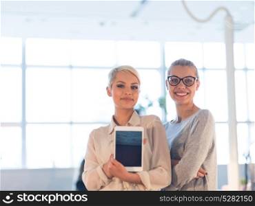 Business Women Using Digital Tablet in Busy Office