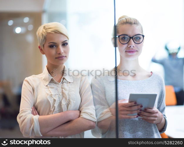 Business Women Using Digital Tablet in Busy Office