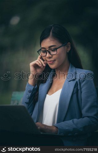 business women using laptop for work in the garden