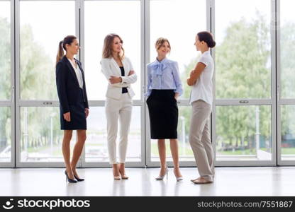 business, work and corporate concept - businesswomen meeting at office and talking. businesswomen meeting at office and talking