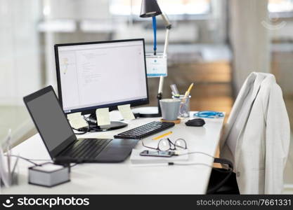 business, work and interior concept - laptop computer, gadgets and stationary on table at office. laptop computer and gadgets on table at office