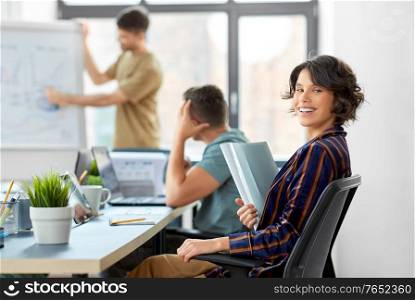 business, work and people concept - smiling businesswoman with folder at office conference. smiling businesswoman at office conference