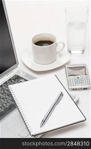 Business workplace pen notepad laptop phone coffee on office desk