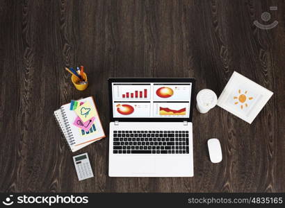 Business workplace with business stuff . Top view of wooden table with laptop and other stuff