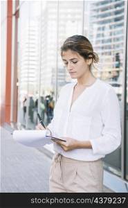 business young woman writing clipboard with pen