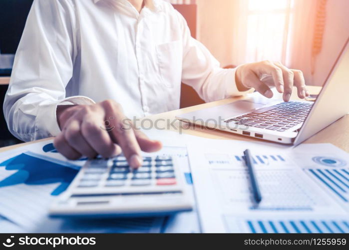 Businessman accountant or financial expert analyze business report graph and finance chart at corporate office. Concept of finance economy, banking business and stock market research.