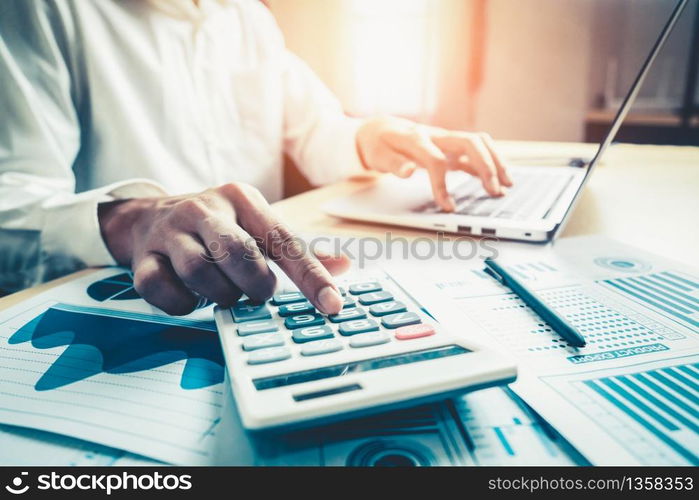 Businessman accountant or financial expert analyze business report graph and finance chart at corporate office. Concept of finance economy, banking business and stock market research.