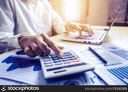 Businessman accountant or financial expert analyze business report graph and finance chart at corporate office. Concept of finance economy, banking business and stock market research.