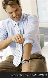 Businessman adjusting his sleeves and smiling