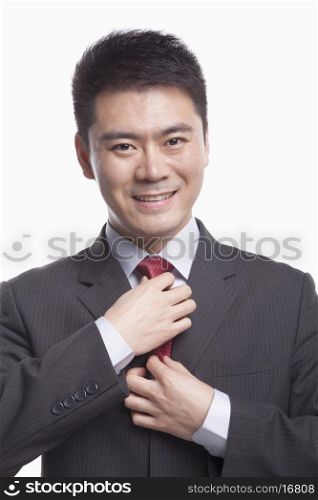 Businessman Adjusting His Tie