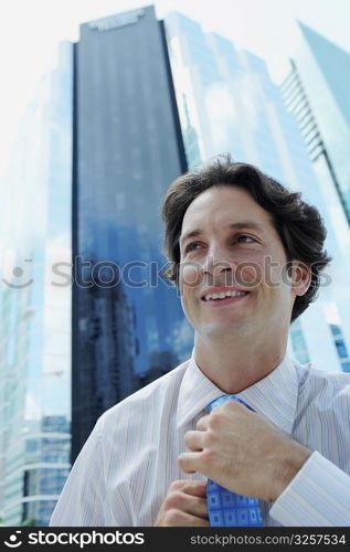 Businessman adjusting his tie