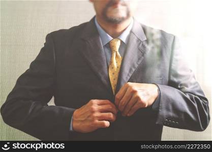Businessman adjusting tie,Front view, no head. Concept of working in an office.filter effect
