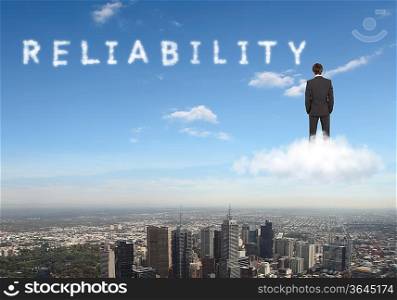 Businessman against blue sky with word reliability writen