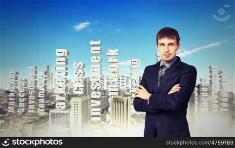 Businessman against cityscape. Successful young businessman standing against modern cityscape