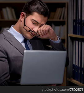 Businessman almost falling asleep working late hours in the office. Businessman almost falling asleep working late hours in the offi