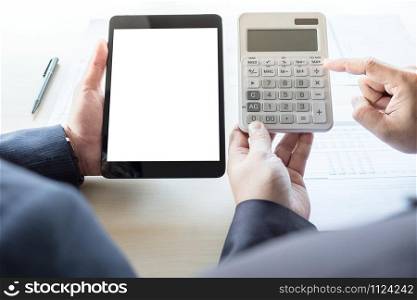 Businessman analysis on calculator, new plan financial graph data with business colleagues using digital tablet for estimation at the office, invesment concept.