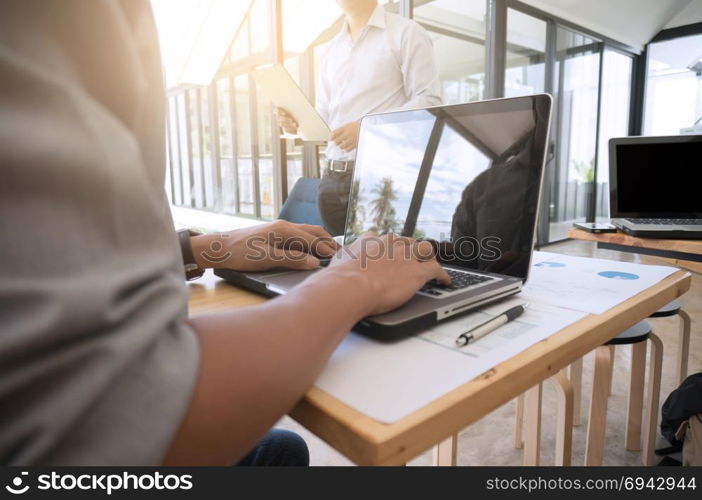 Businessman analyzing investment charts and pressing calculator buttons over documents. Accounting Concept