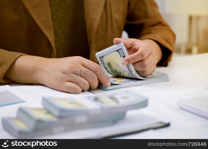 Businessman analyzing investment charts and pressing calculator buttons over documents. Accounting Concept