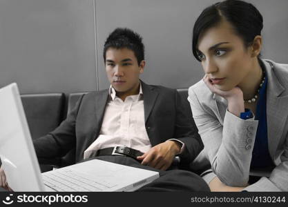 Businessman and a businessman looking at a laptop