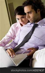 Businessman and a businesswoman in front of a laptop