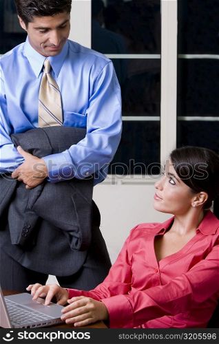 Businessman and a businesswoman looking at each other