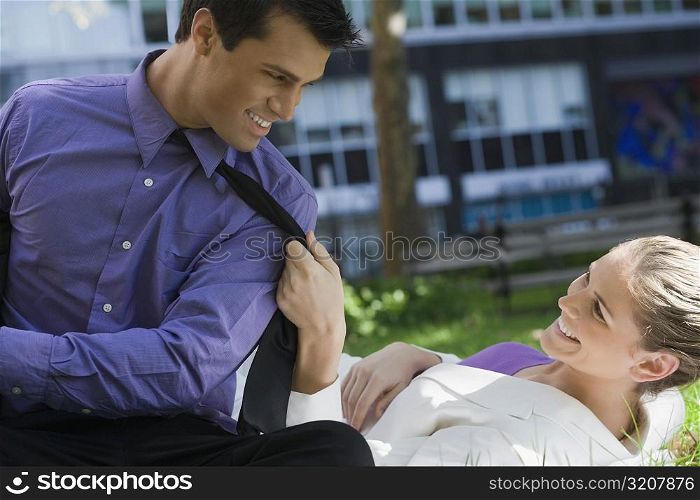 Businessman and a businesswoman looking at each other and smiling