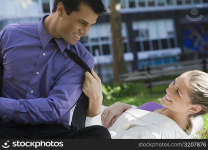 Businessman and a businesswoman looking at each other and smiling