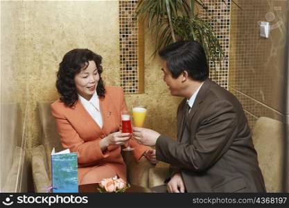 Businessman and a businesswoman sitting in a restaurant