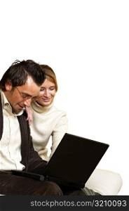 Businessman and a businesswoman sitting in front of a laptop