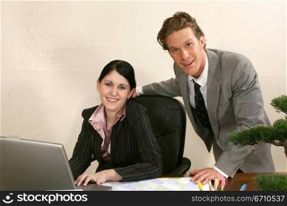 Businessman and a businesswoman smiling