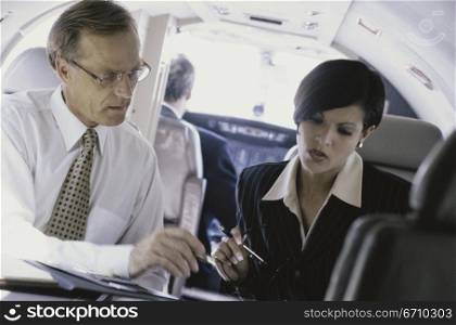 Businessman and a businesswoman talking to each other