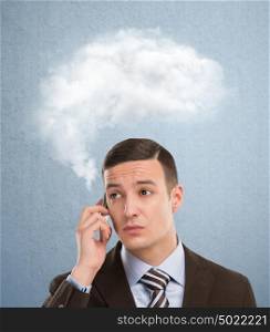 Businessman and a cloud of thoughts on a blue background