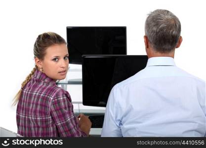Businessman and a young woman in front of a computer