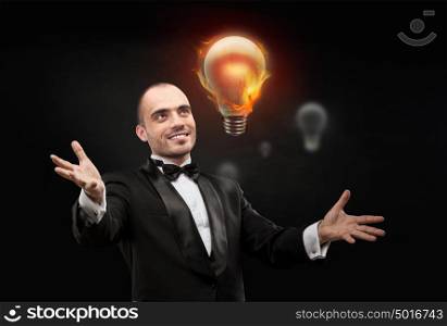Businessman and burning bulb. Business man having great hot idea