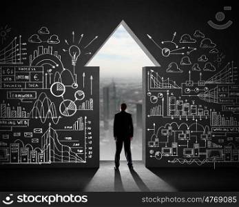 Businessman and business plan. Silhouette of businessman against black wall. Business direction