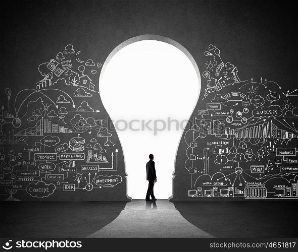 Businessman and business plan. Silhouette of businessman against black wall. Idea concept