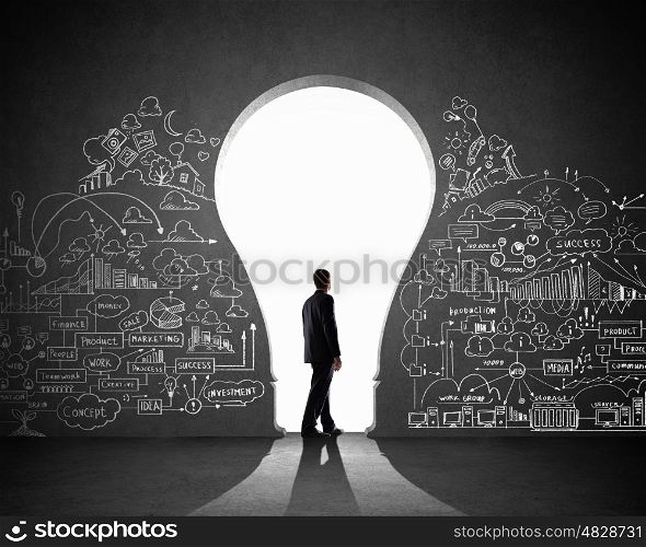 Businessman and business plan. Silhouette of businessman against black wall. Idea concept