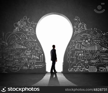 Businessman and business plan. Silhouette of businessman against black wall. Idea concept