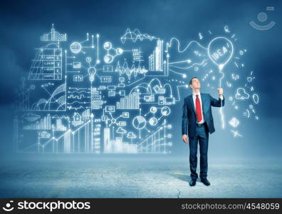 Businessman and business sketch. Image of young businessman standing against business sketch