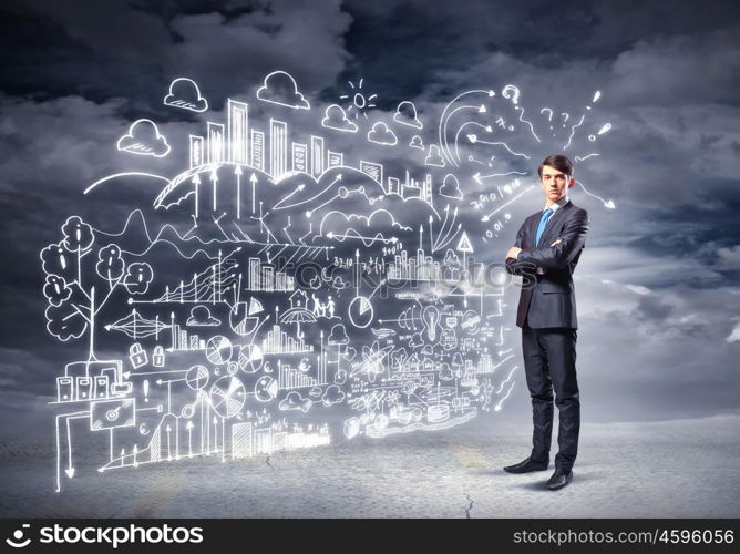 Businessman and business sketch. Image of young businessman standing against business sketch