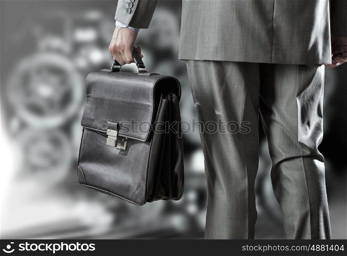 Businessman and business sketches. Rear view of businessman with suitcase in hand