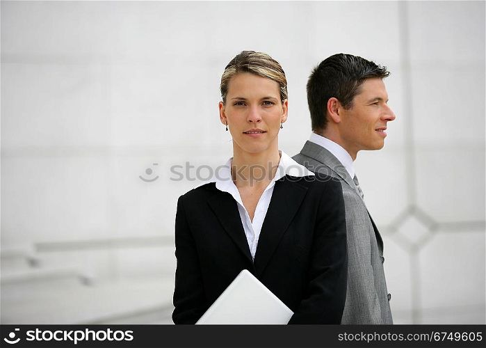 businessman and businesswoman back to back