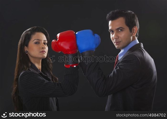 Businessman and businesswoman boxing