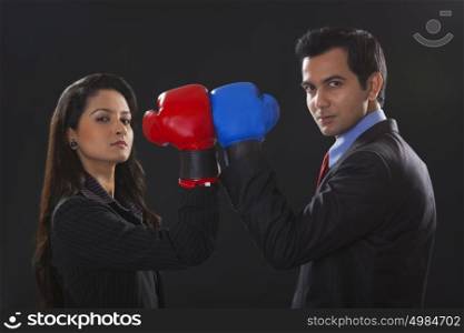 Businessman and businesswoman boxing
