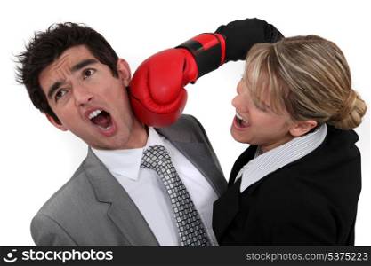 businessman and businesswoman boxing