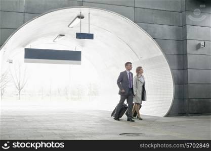 Businessman and businesswoman entering railroad station
