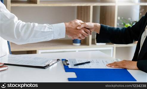 businessman and businesswoman handshaking over the office desk after Greeting new colleague, business meetings concept