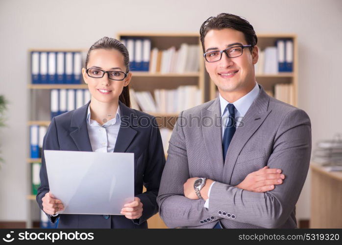 Businessman and businesswoman having discussion in office