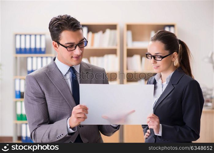 Businessman and businesswoman having discussion in office
