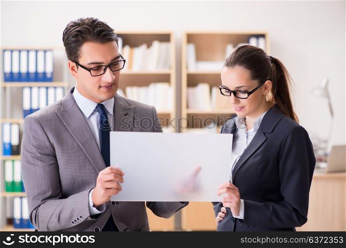 Businessman and businesswoman having discussion in office